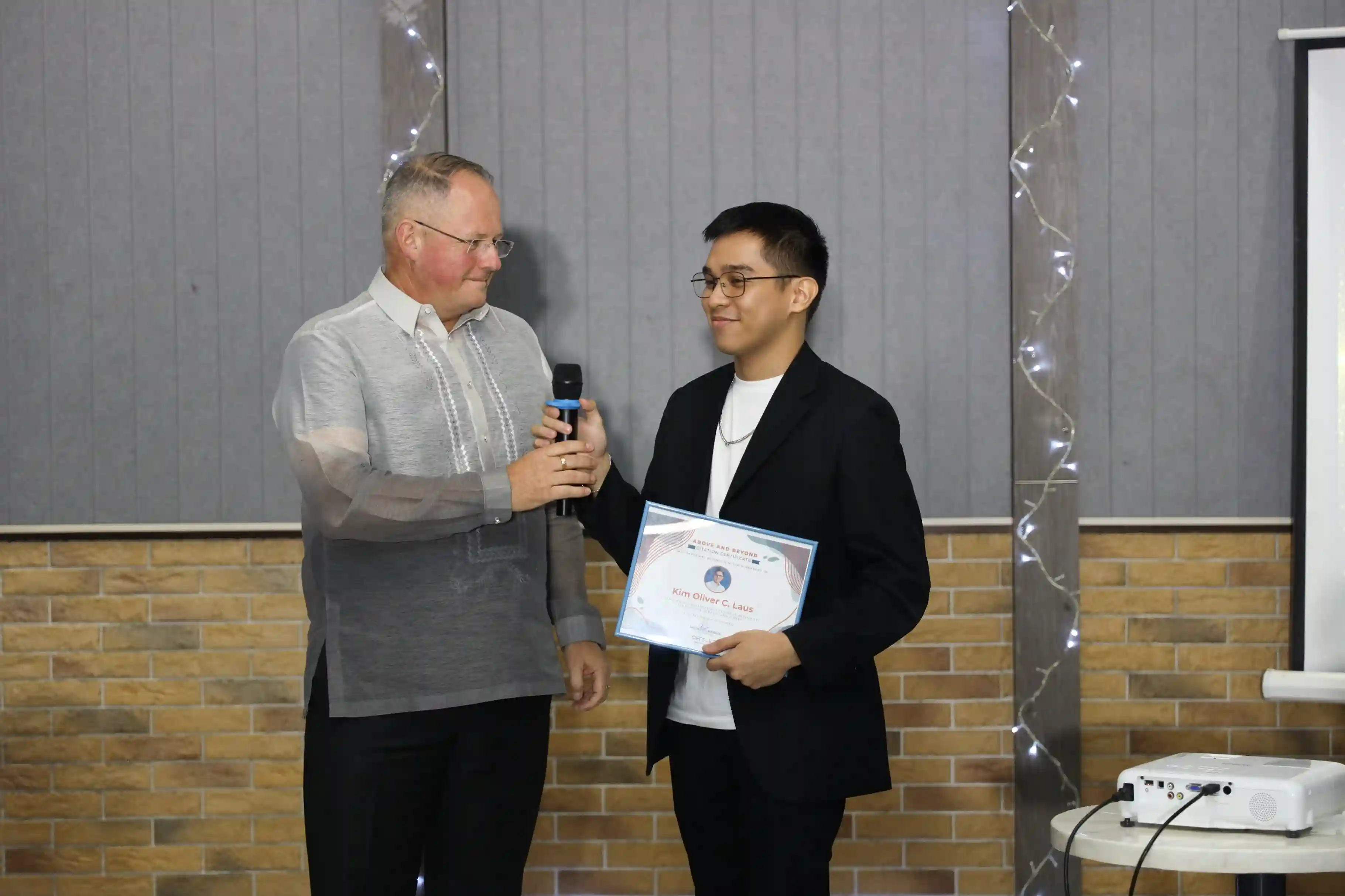 Kim, the founder of LinkDeets, receiving an Above and Beyond citation at an event
