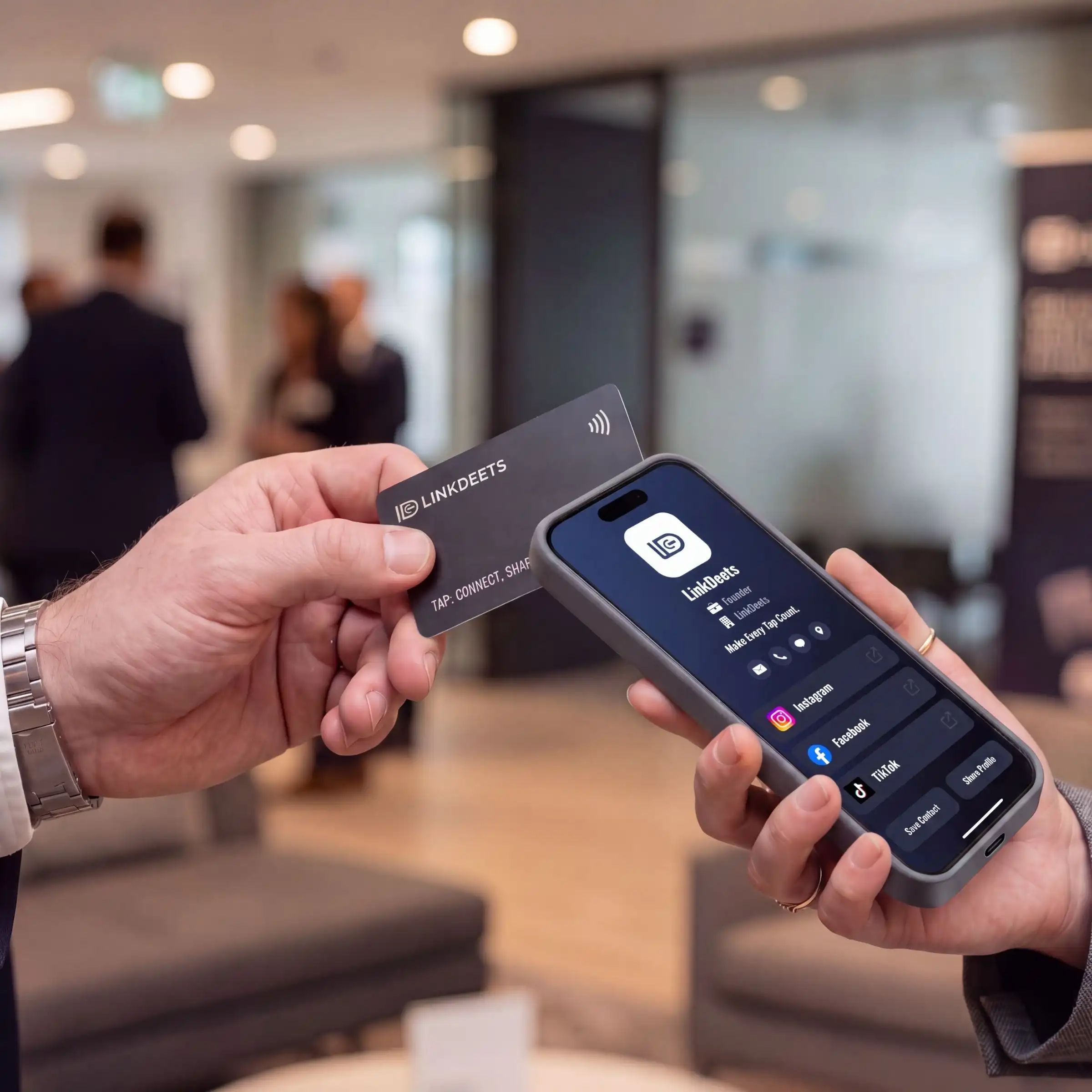 A LinkDeets card tapped against a phone, the owner's profile open on screen